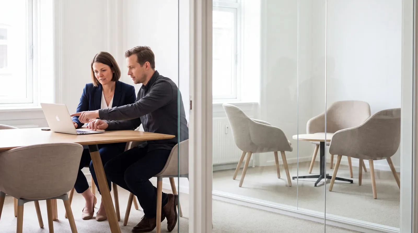 Hiring manager and recruiter reviewing screening evidence before scheduling interviews
